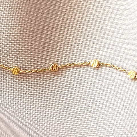 Gold Nebula Bracelet on a satin sheet