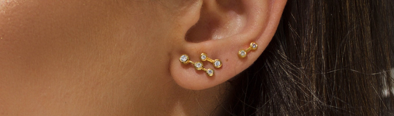 person wearing Large and Small Star Dust Studs in gold