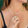 Woman wearing 4 gold chains: Nebula Necklace, Mini After Glow Pendant, Anchor Chain, Thin Chain and 14K Gold and Opal One of a kind necklace.  With hand in photo wearing the Gold Aura ring and Moonstone Coeus Ring