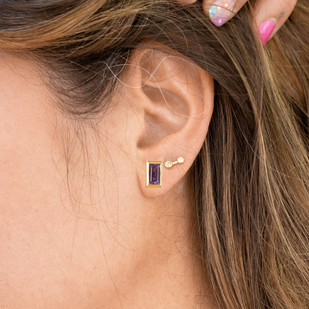 Woman wearing amethyst and Gold Rectangle Gemstone Glow Studs and Small Stardust Studs