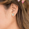 Woman wearing sky blue topaz  and Gold Rectangle Gemstone Glow Studs and Small Stardust Studs