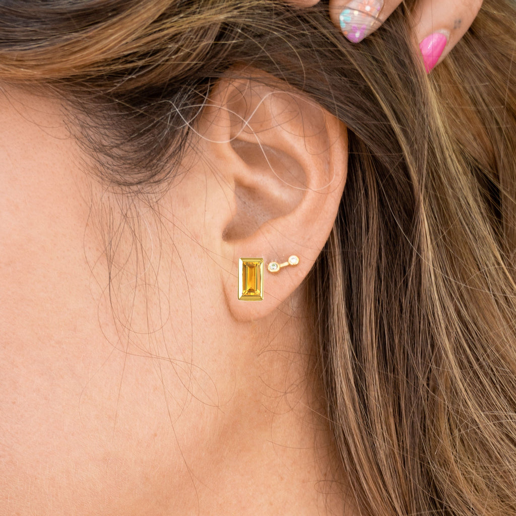 Woman wearing Citrine and Gold Rectangle Gemstone Glow Studs and Small Stardust Studs
