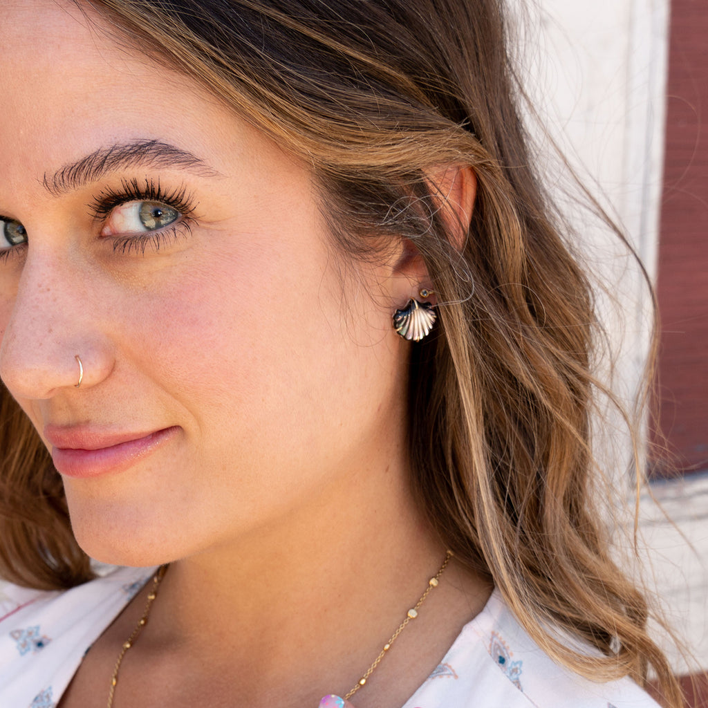 Woman wearing Clam Shell Stud Earrings in 14K Gold and Black Mother of Pearl