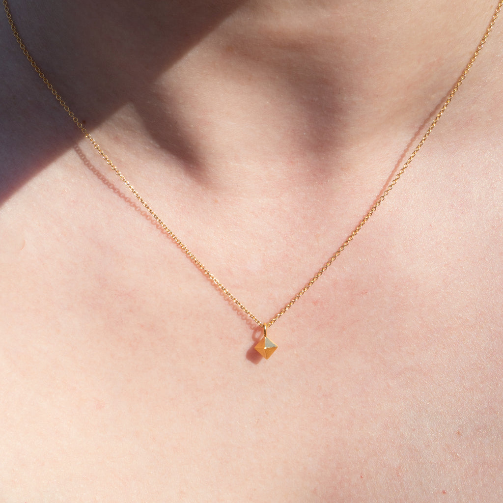 Person wearing Gold Faceted Pendant