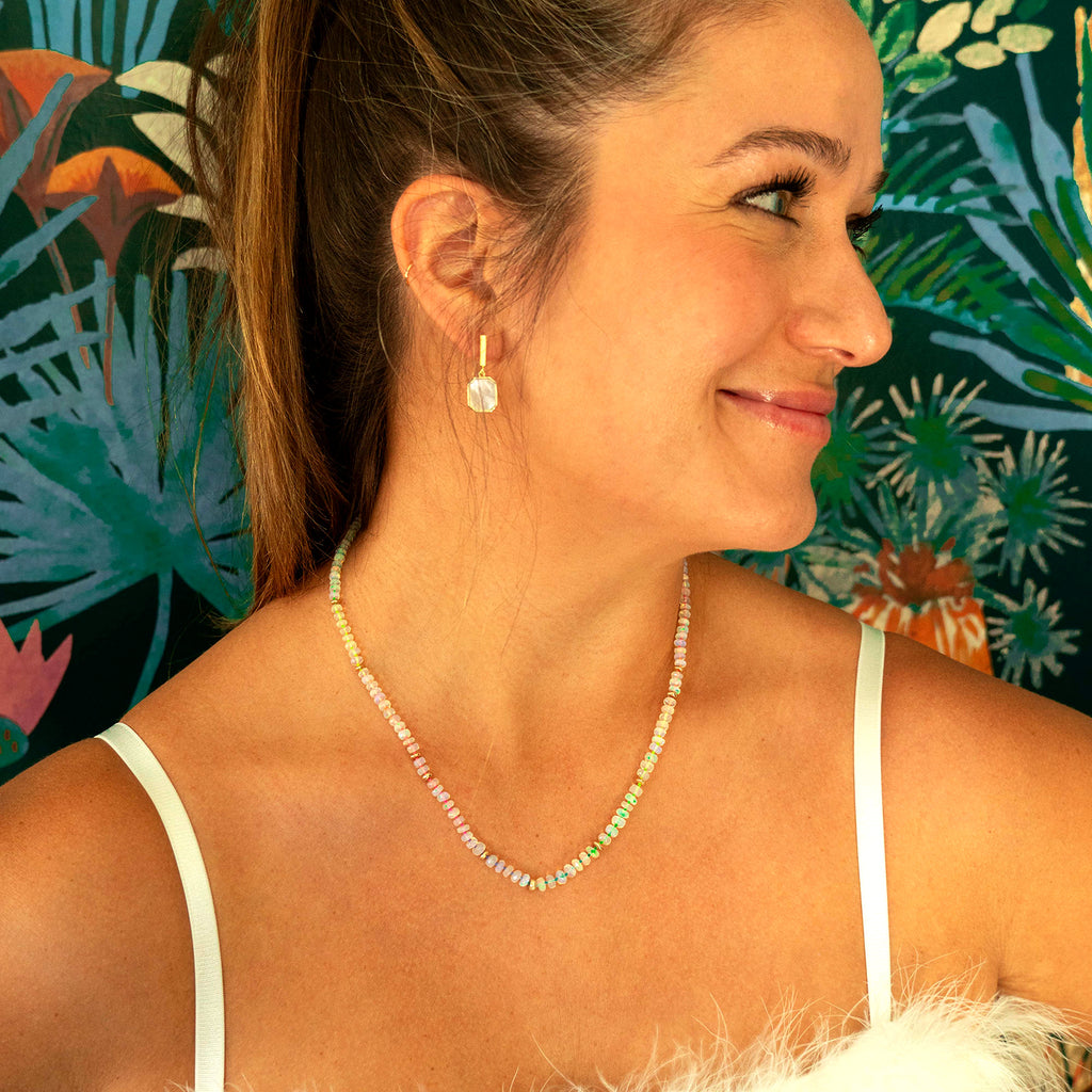 woman wearing Mother of Pearl Sunrise Earrings and 14k gold and opal necklace