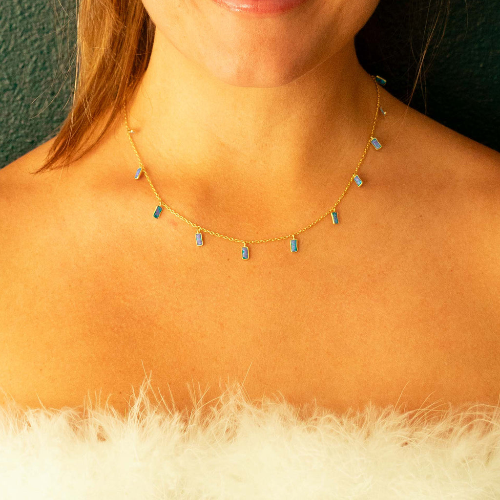 Woman wearing Gold chain with 11 rectangle Blue Opal charms