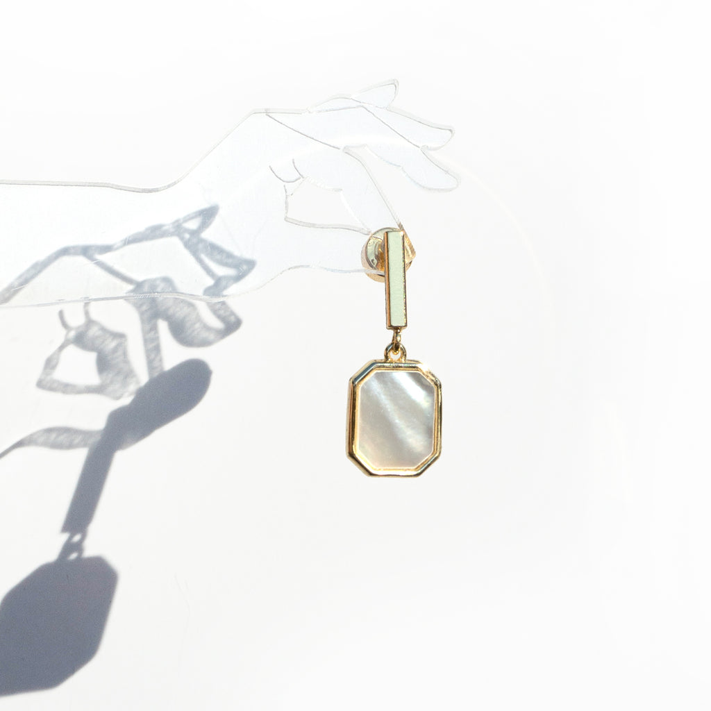 Mother of Pearl Sunrise Earrings head by clear acrylic hand