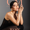 A professional beauty editorial portrait of model Daisy Marquez, featured on the cover of 'CM by Composure' magazine. She is wearing a sheer black and large gold Petal Hoop earrings by Cat Janiga