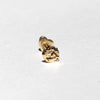 A single small gold stud earring with a textured, organic-shaped clear stone, photographed on a plain white background.