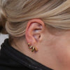 Person wearing a black jacket with a neutral background and oracle claw ear jacket