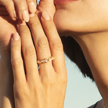 Close up of Gold  and moonstone Andromeda Ring worn on a manicured hand