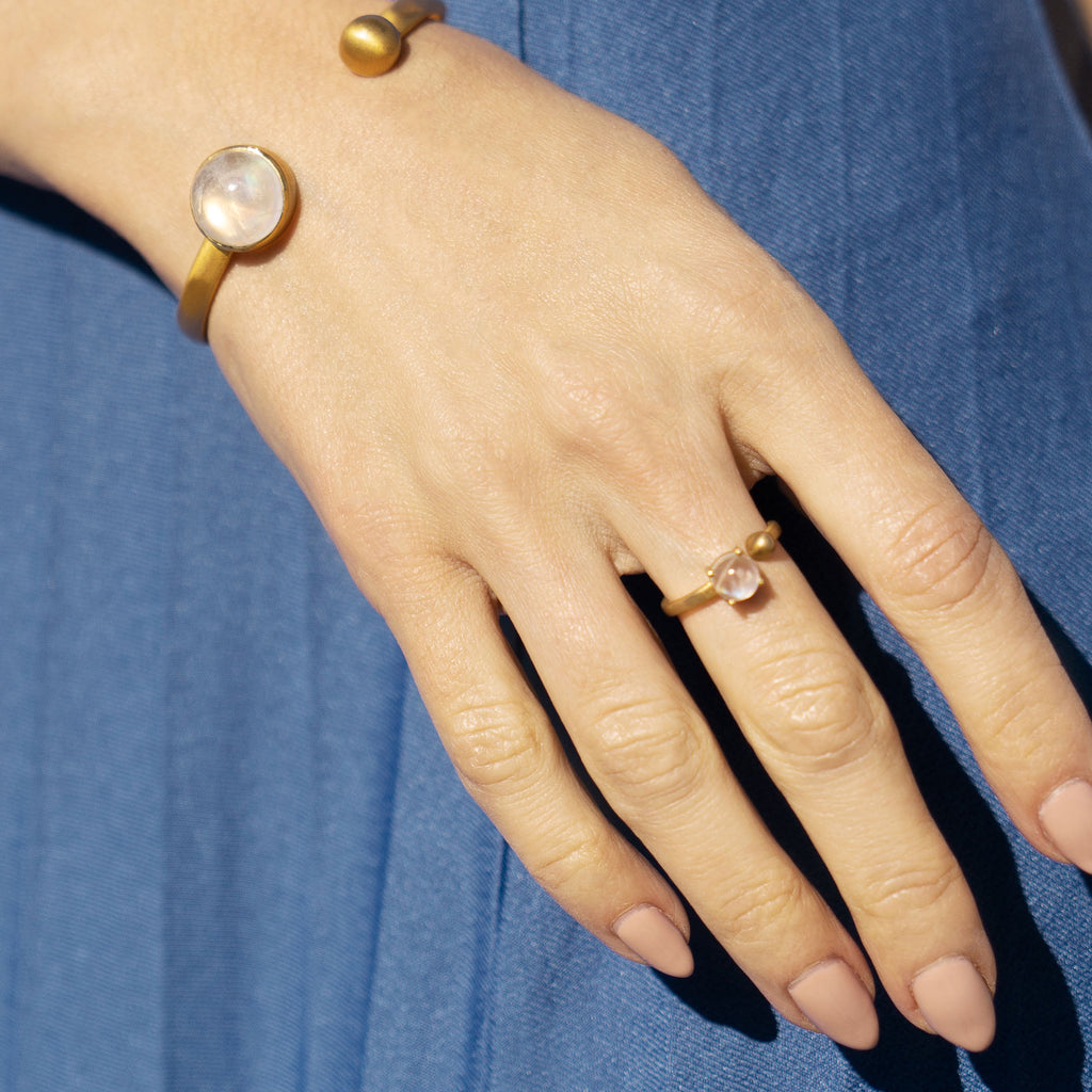 Hand wearing Moonstone and Gold Coeus Ring and Cuff