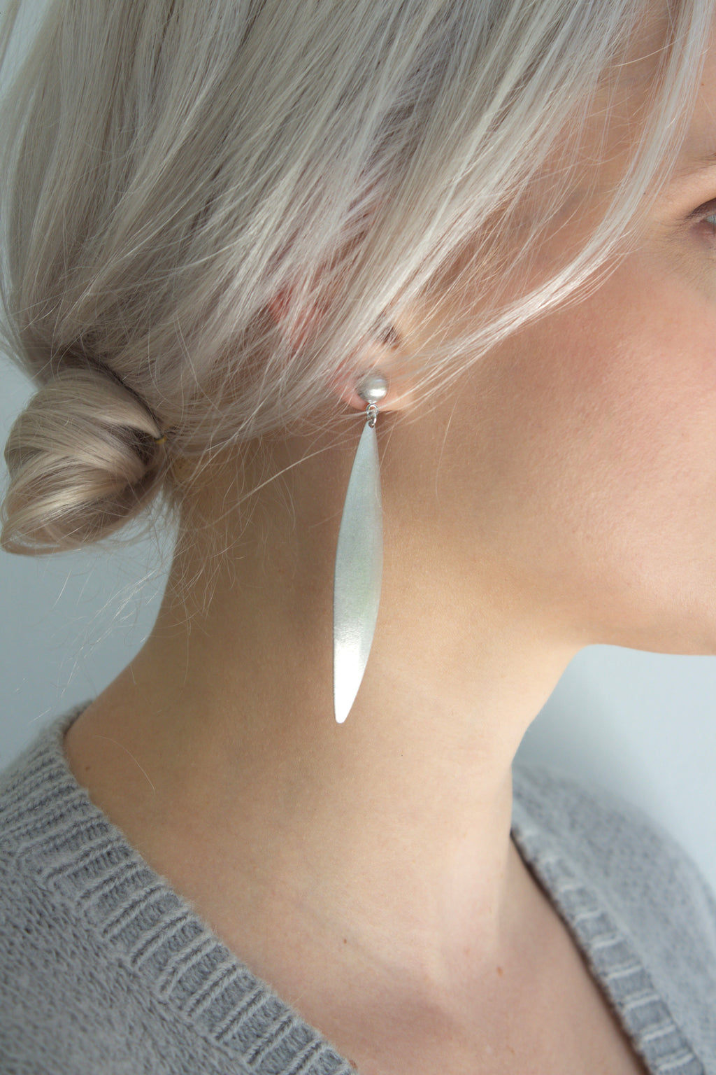 Woman wearing silver dune earrings