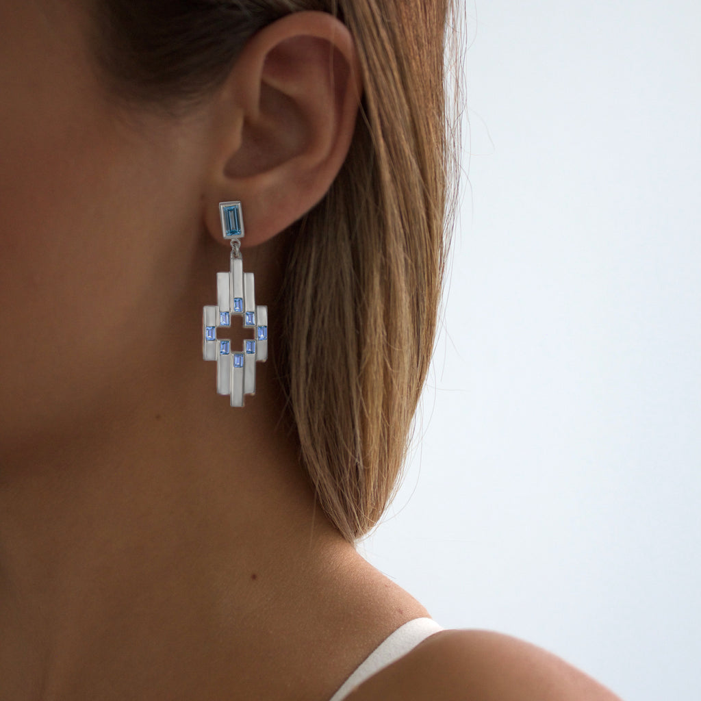 Close up of woman wearing the Swiss Blue Topaz and Silver Aurora Earrings