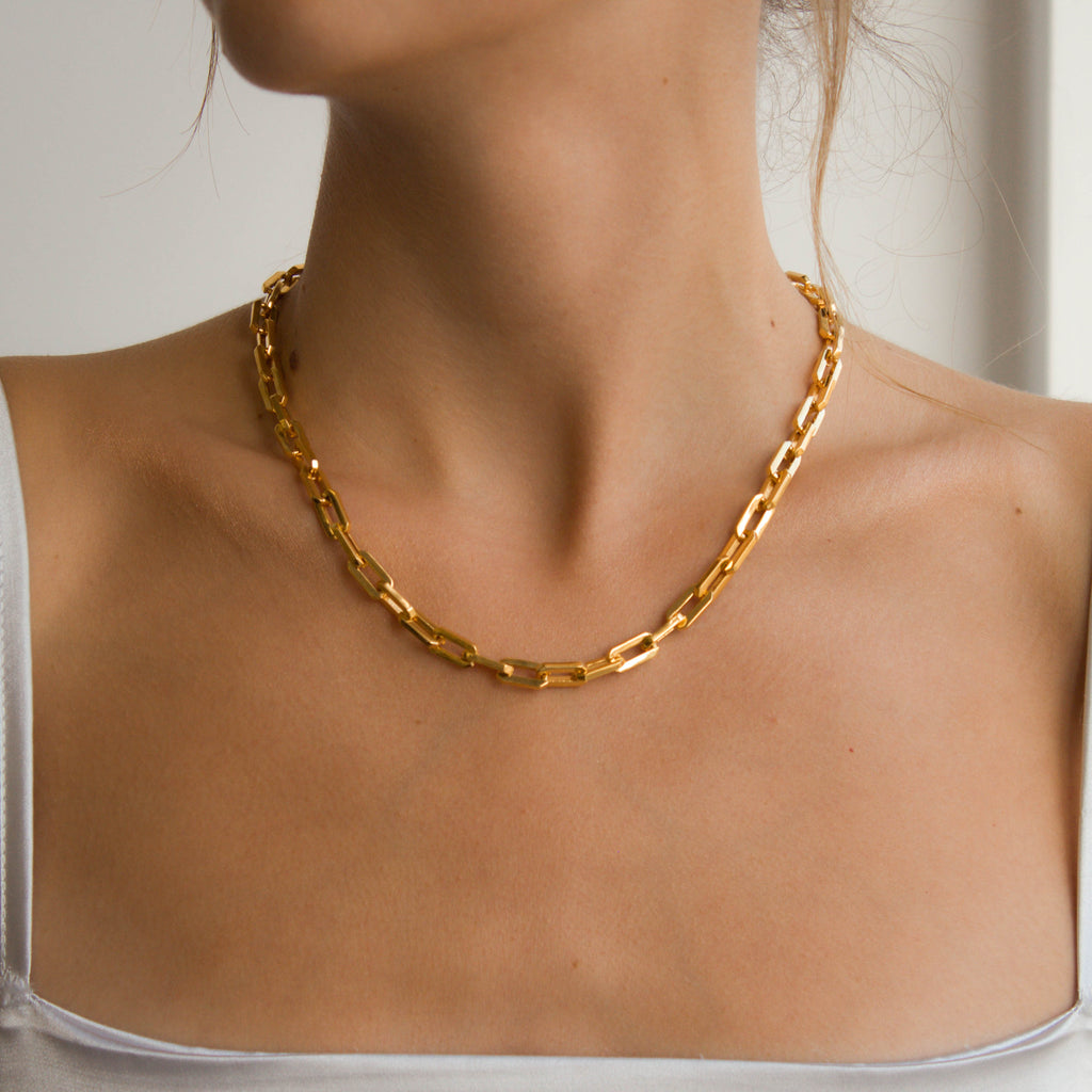Woman wearing gold Sol Link Necklace